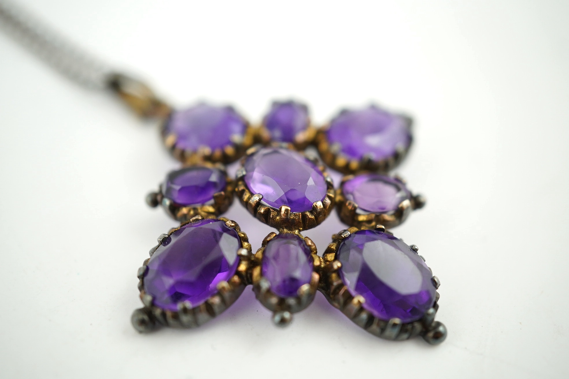 An amethyst pendant, 40mm, on a 9ct gold chain. Condition - fair